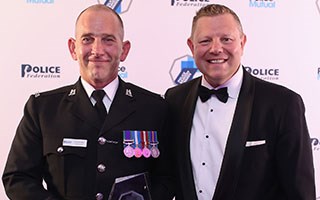 Warwickshire officer who took the weight of a car on his back wins award
