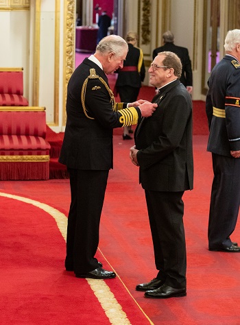 David Wilbraham receiving his MBE from Prince Charles (PA Images)